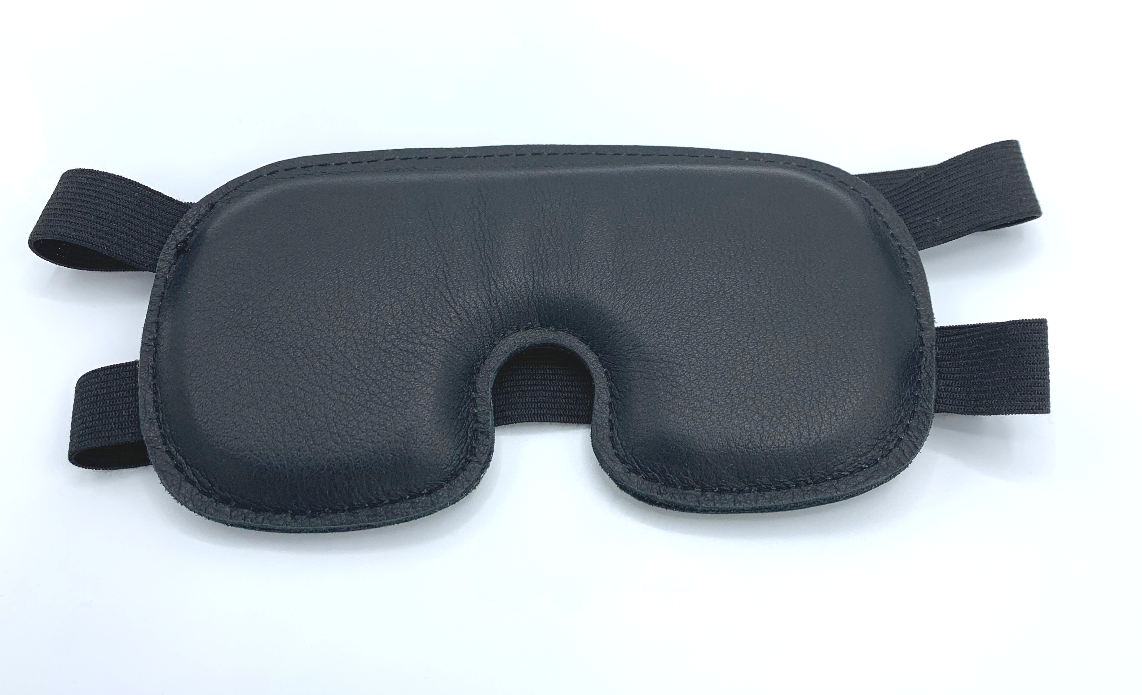 Luxuriöse schwarze Augenmaske mit Schaumstoffpolsterung, feinem Lederbezug und elastischen Doppelbändern für sicheren Halt ohne Druckstellen.